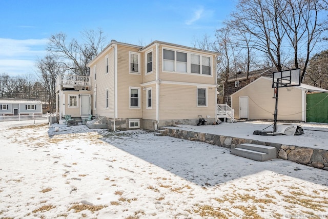 view of snow covered back of property