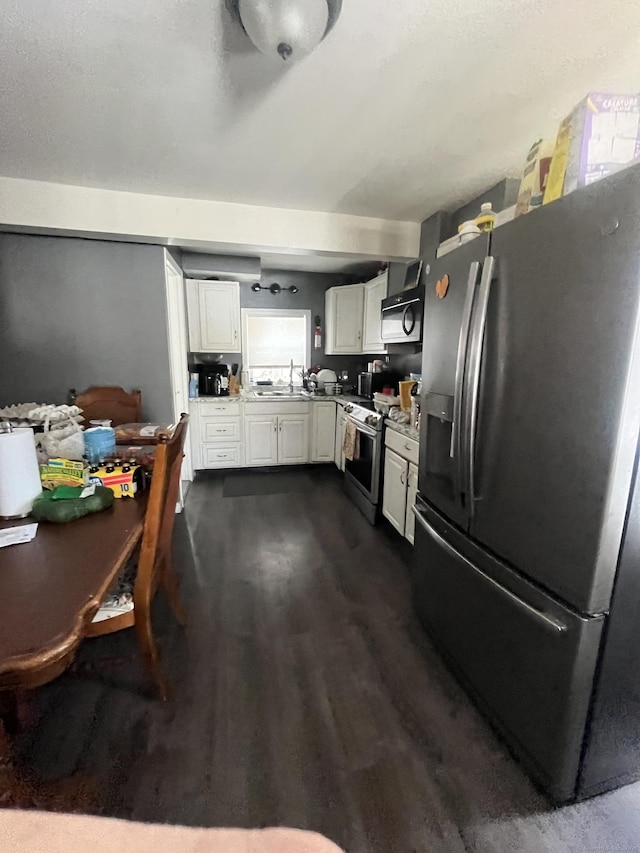 kitchen with white cabinetry, sink, dark wood-type flooring, and stainless steel appliances