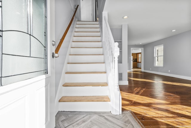 stairway with parquet flooring