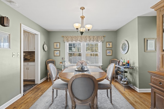 dining space featuring a chandelier and light wood-type flooring