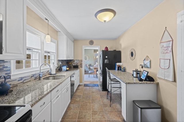 kitchen featuring a kitchen bar, sink, tasteful backsplash, pendant lighting, and white cabinets