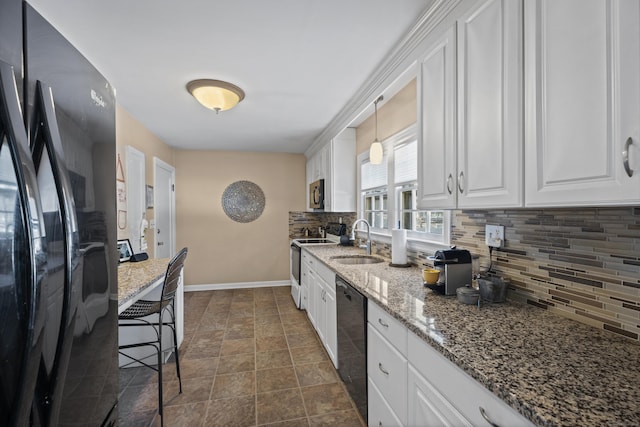 kitchen with sink, black appliances, hanging light fixtures, decorative backsplash, and white cabinets