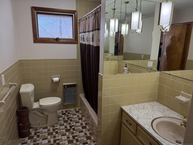 bathroom with toilet, shower / bath combination with curtain, tile walls, tile patterned flooring, and vanity