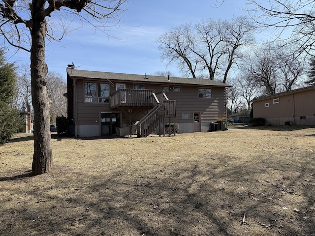 rear view of house featuring a wooden deck, a chimney, and stairs