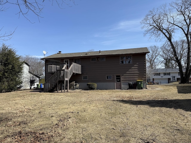 rear view of house featuring stairs and a deck