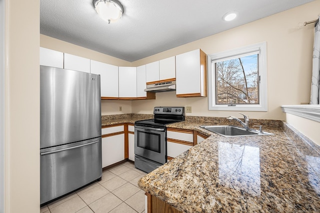 kitchen with sink, white cabinetry, a textured ceiling, light tile patterned floors, and appliances with stainless steel finishes