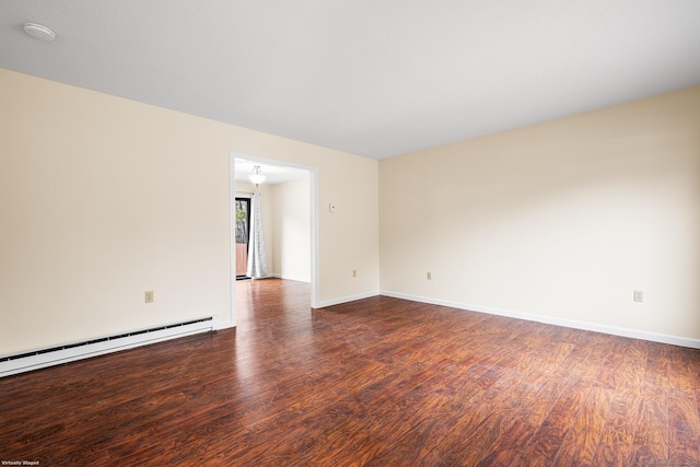 unfurnished room with a baseboard radiator and dark hardwood / wood-style floors