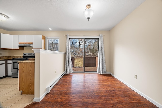 kitchen with light hardwood / wood-style flooring, baseboard heating, stainless steel range with electric stovetop, a textured ceiling, and white cabinets