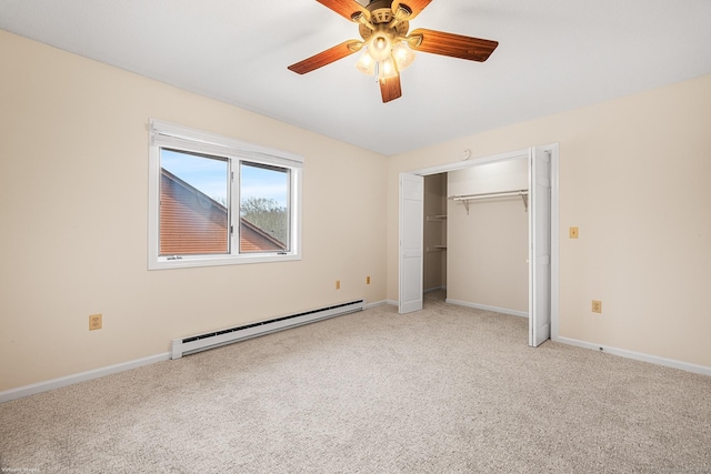 unfurnished bedroom with carpet floors, a baseboard heating unit, ceiling fan, and a closet