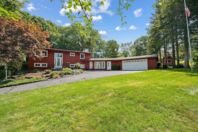 view of front facade with a garage and a front yard