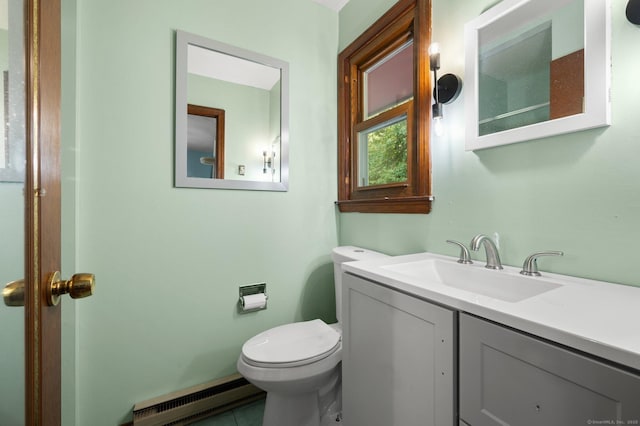 bathroom with tile patterned floors, vanity, toilet, and a baseboard heating unit