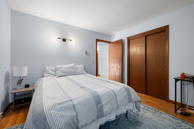 bedroom featuring hardwood / wood-style flooring and a closet