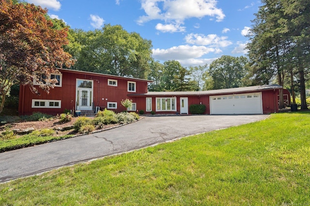 view of front of house featuring a garage and a front lawn