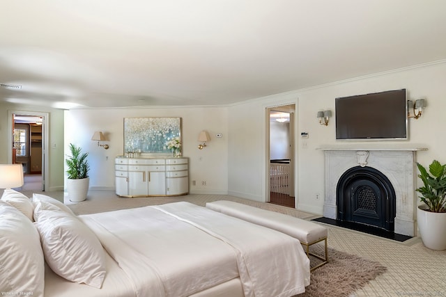 bedroom with light carpet and a premium fireplace