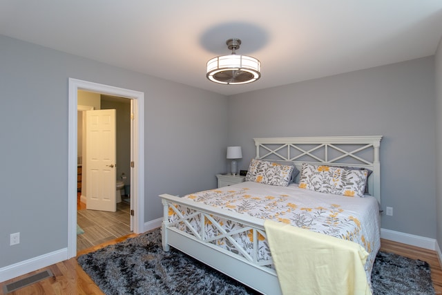 bedroom with hardwood / wood-style floors