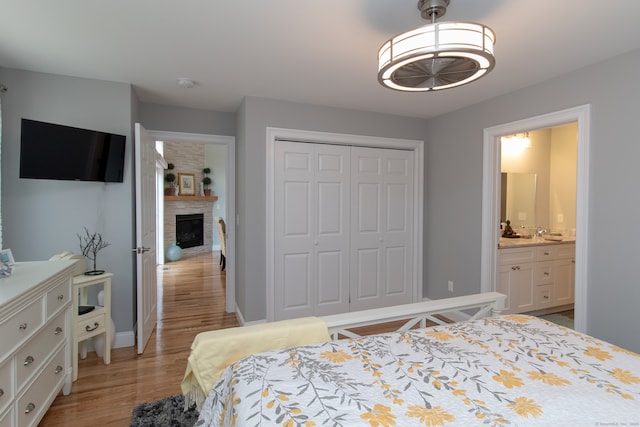 bedroom with light hardwood / wood-style floors and a closet