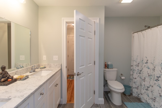 bathroom with vanity, wood-type flooring, toilet, and walk in shower