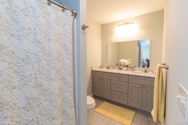 bathroom featuring vanity, toilet, and walk in shower