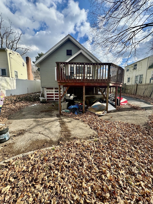 back of house with a deck and a patio area