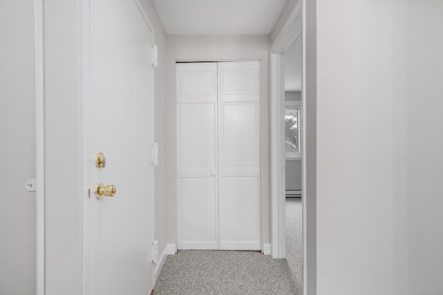 corridor with a baseboard radiator and carpet flooring