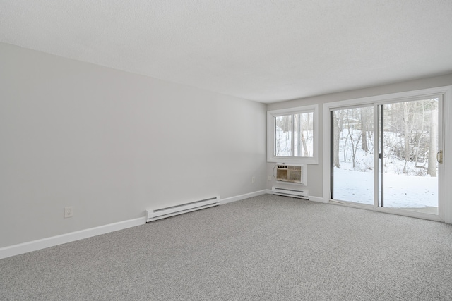 empty room featuring baseboard heating, carpet flooring, and a wall unit AC