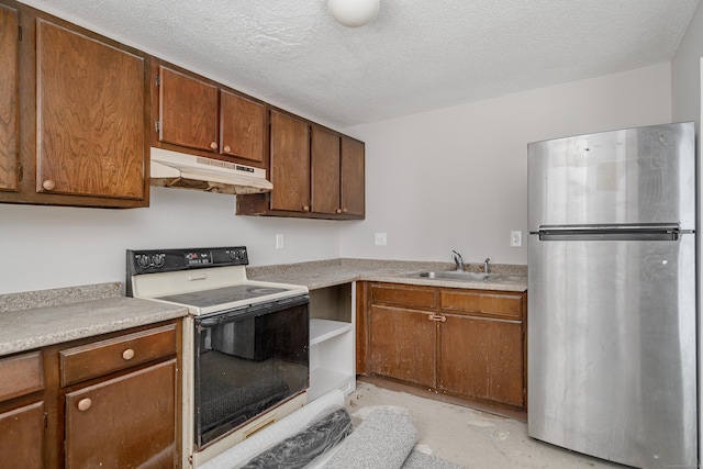 kitchen featuring stainless steel refrigerator, sink, a textured ceiling, and range with electric cooktop