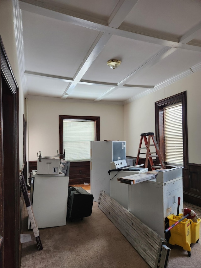office featuring beam ceiling, a wealth of natural light, coffered ceiling, and carpet floors
