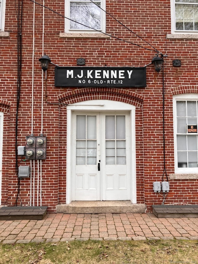 doorway to property with brick siding