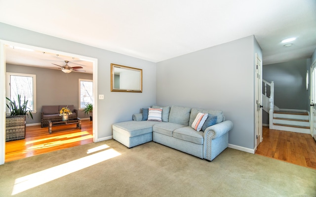 carpeted living room featuring ceiling fan