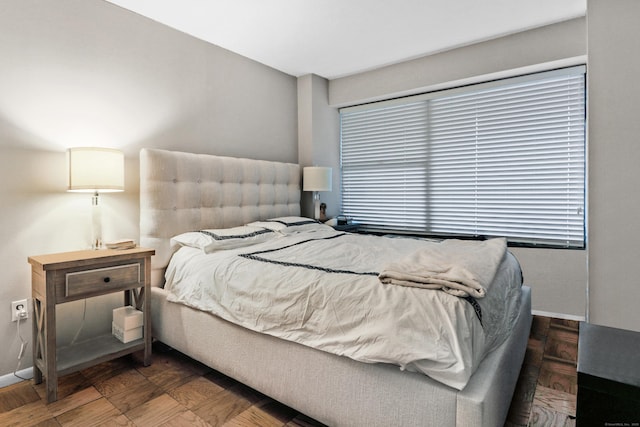 bedroom with dark parquet floors