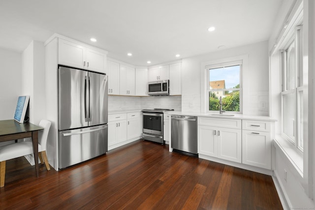 kitchen featuring white cabinetry, sink, decorative backsplash, and appliances with stainless steel finishes