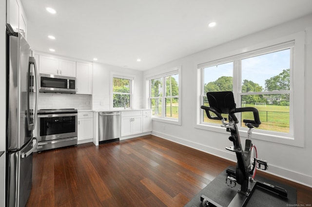 kitchen featuring appliances with stainless steel finishes, white cabinets, and dark hardwood / wood-style flooring