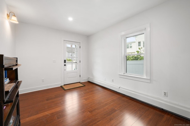 entrance foyer featuring baseboard heating and dark wood-type flooring