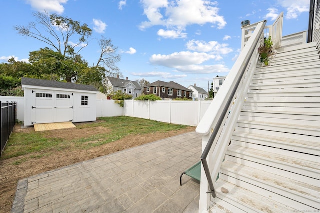 view of patio with a storage shed