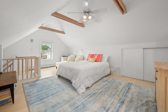 bedroom with vaulted ceiling with beams, ceiling fan, a closet, and light wood-type flooring