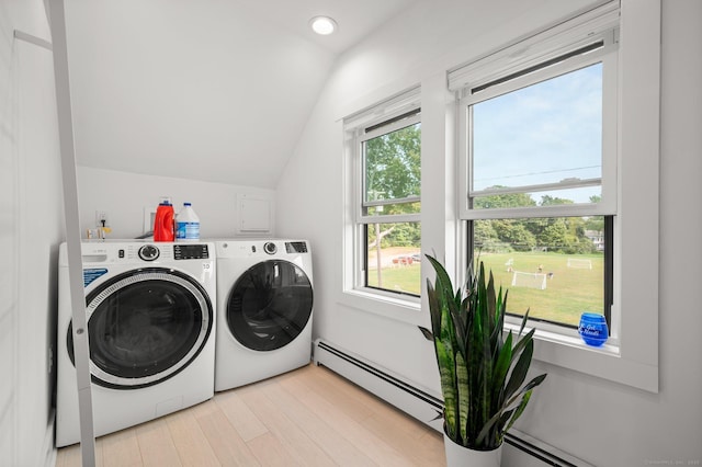 laundry area featuring a baseboard heating unit, a wealth of natural light, and independent washer and dryer