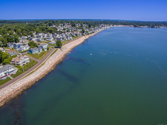 bird's eye view with a water view and a beach view