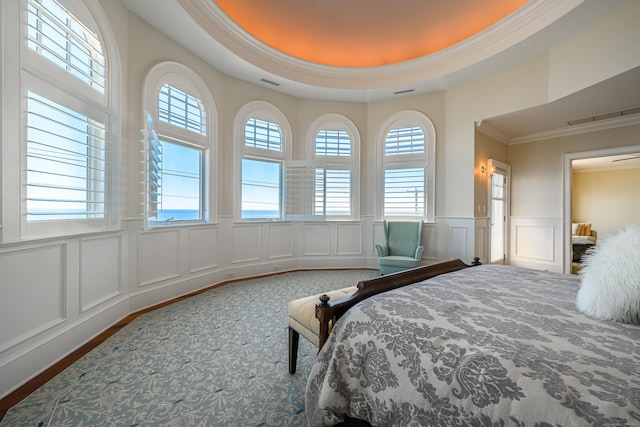 bedroom featuring crown molding and a raised ceiling