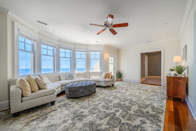 living room featuring hardwood / wood-style floors, ornamental molding, and a water view