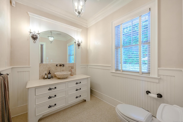 bathroom with ornamental molding, toilet, and vanity