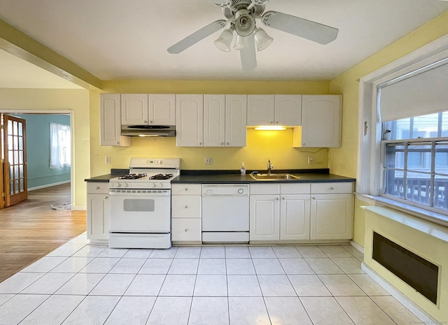 kitchen with white appliances, sink, and white cabinets