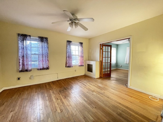 empty room featuring ceiling fan and light wood-type flooring