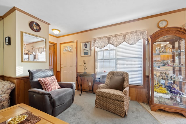 sitting room featuring crown molding, light colored carpet, and wood walls