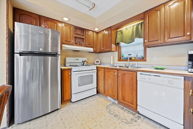 kitchen featuring white appliances and sink