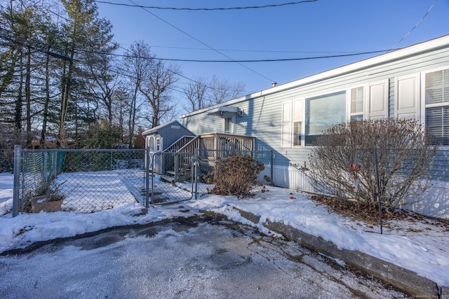 snow covered property with a deck