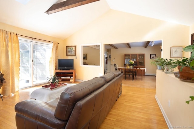 living room with lofted ceiling with skylight and light wood-type flooring