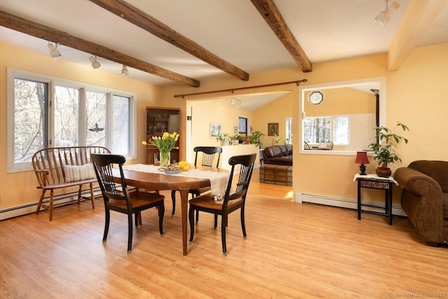 dining space featuring light hardwood / wood-style flooring and a baseboard radiator