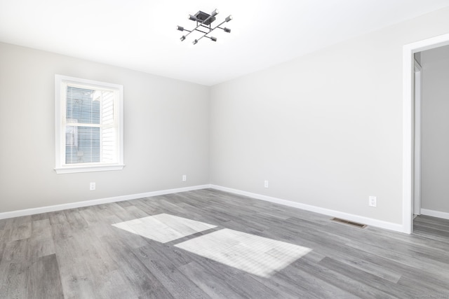 unfurnished room featuring light hardwood / wood-style floors