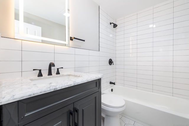 full bathroom with tile walls, tiled shower / bath combo, vanity, decorative backsplash, and toilet