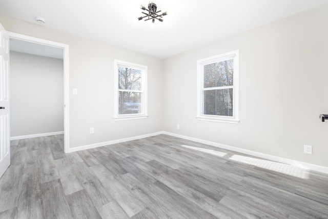 unfurnished room with light hardwood / wood-style floors